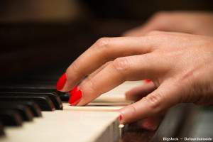 Female pianist hands closeup and piano keyboard